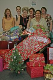 PhotoID:5224, Office of Research staff present Anglicare's Marian Vickery with the enormous donation of goodies. From left: Director of the Office of Research Megan Barrett, Jessica Gudmann, Marian Vickery (Anglicare), Leslie Walker, Moti Hooper and  Sue Evans.