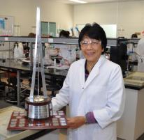 PhotoID:12889, Event coordinator Dr Vicky Vicente-Beckett holding the QAL trophy for the CQ Titration Competition