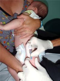 PhotoID:10565, Dr John McGrath's daughter Emma receiving her two-month-old vaccinations.