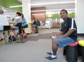 PhotoID:13123, Martin Muekia relaxes in the campus library towards the end of his MBA study