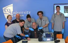 PhotoID:13096, L-R Ebony Edges, Kree Combey, Paul Oliveri (Paramedic Lecturer), Linda Beecheno, Matt Ewing and Yanick Juvet perform a 'check up' on the VC Scott Bowman. 