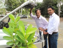 PhotoID:12272, Researcher Subhash (right) and Ashwath pictured with a Beauty Leaf Tree beside a 4WD engine