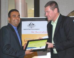 PhotoID:12091, Ramesh receives his award in 2011 from Peter Linford, the Senior Trade & Investment Commissioner - South Asia