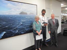 PhotoID:13710, Artist Peter Anderson is flanked by Art Collection Manager Sue Smith and Chancellor Rennie Fritschy during a ceremony to welcome the painting to Rockhampton Campus