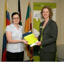 PhotoID:13891, Marie Toman receives an achievement certificate from Lara Carton