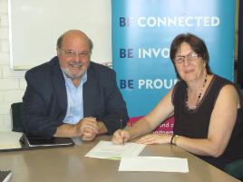 PhotoID:10021, Queensland Alliance Program Director Mike Wilson and Professor Brenda Happell sign an MOU to arrange campus space for Regional Mental Health Coordinators