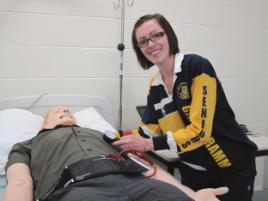 PhotoID:10662, Rebecca Howard with one of the Paramedic Science SimMan manikins