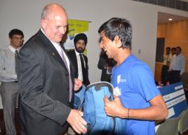 PhotoID:11549, Professor Bowman presents a CQUniversity Australia bag to one of the 'WALK into the street life of Delhi' guides.