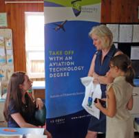 PhotoID:6774, CQUniversity's Promotions and Recruitment Officer Crystal Chopping talks with a mum and daughter about the prospects of studying through the SUN program.