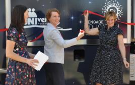 PhotoID:13166, Education Queensland rep Deborah Ilott (centre) cuts a ribbon to 'open' the MET, watched by Stacey Wallace and Barbara Lawrence from CQUniversity