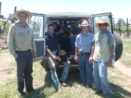 PhotoID:6880, AACC instructor Don Wills (left) with a group of AACC participating students (inside the car), and CQUniversity researcher Dr Pramod Shrestha (right), finishing the session on installation of subsurface drip irrigation