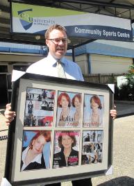 PhotoID:10327, Government Relations Manager Martin Elms displays the unique auction item outside the building used to house flood evacuees