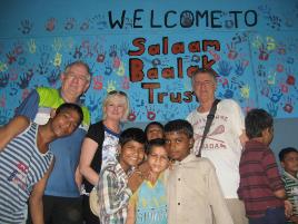 PhotoID:13219, CQUni reps Darryl Stewart, Fae Martin and Roger March with kids at the community centre