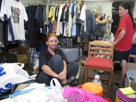 PhotoID:10351, Jessica in a sea of donated clothes and household goods, along with a few of her helpers