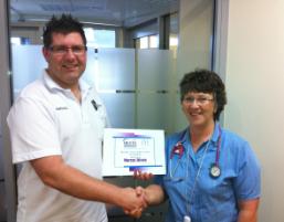 PhotoID:12789, Marcus receives his award during a practicum placement at North West Regional Hospital (NWRH) Burnie, Tasmania. He's congratulated by emergency department clinical nurse Jan Robertson