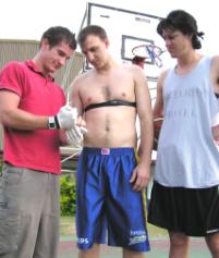 PhotoID:5541, Aaron Scanlan (centre) prepares to test Rockhampton baskbetballers Craig Bosel (left) and Tony Campbell