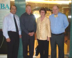 PhotoID:11653, In younger days, professors Kevin Tickle, Graham Pegg, Debbie Clayton and Alan Knight during a visit to Hartford Institute, Singapore, in 2004 to discuss CQUniversity's transnational education partnership activities