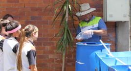 PhotoID:11738, Graham Fox showing students how to connect the pipe work