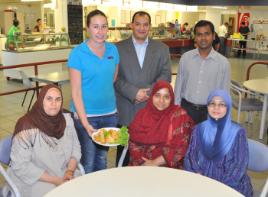 PhotoID:11375, Kellyn Bellert serves up some halal menu items to L-R Fatma Aly, Dr Mohamed Elsayed, Sumaira Tasnim, Khokan Bepari and Wan Zuriati 