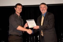 PhotoID:12691, (L-R) CQUniveristy Multimedia Studies student Jason Craddock receives the People's Choice Award from SimTecT Serious Games Showcase and Challenge Director Ken Gritton