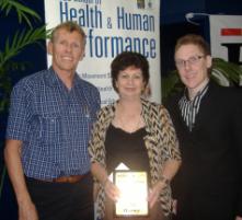 PhotoID:4963, Associate Professor Peter Reaburn (left) and The Morning Bulletin's Aaron Kelly present the award to Del Harney. Photo courtesy The Morning Bulletin