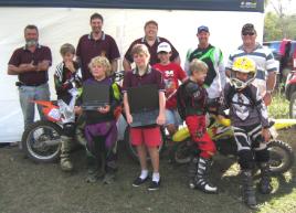 PhotoID:14974, CQUni representative Allan Gadsby (left) with members of the Capricorn Dirt Riders and their laptops